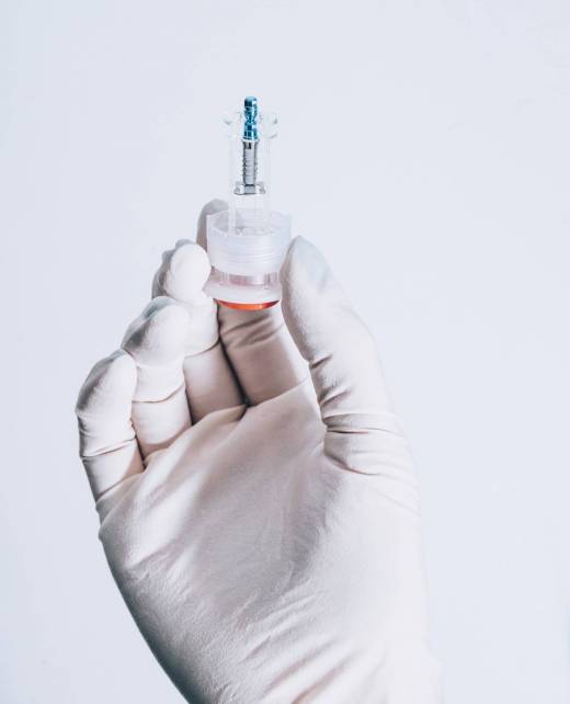 Hand holding a dental implant